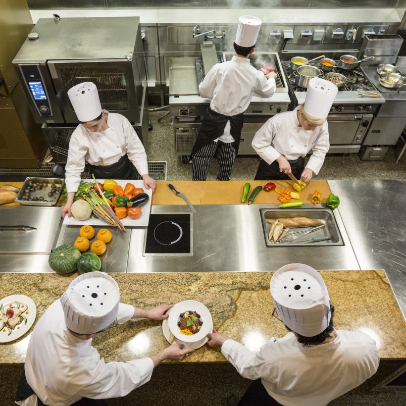 a-view-looking-down-on-a-crew-of-chefs-working-in-a-commercial-kitchen-.jpg